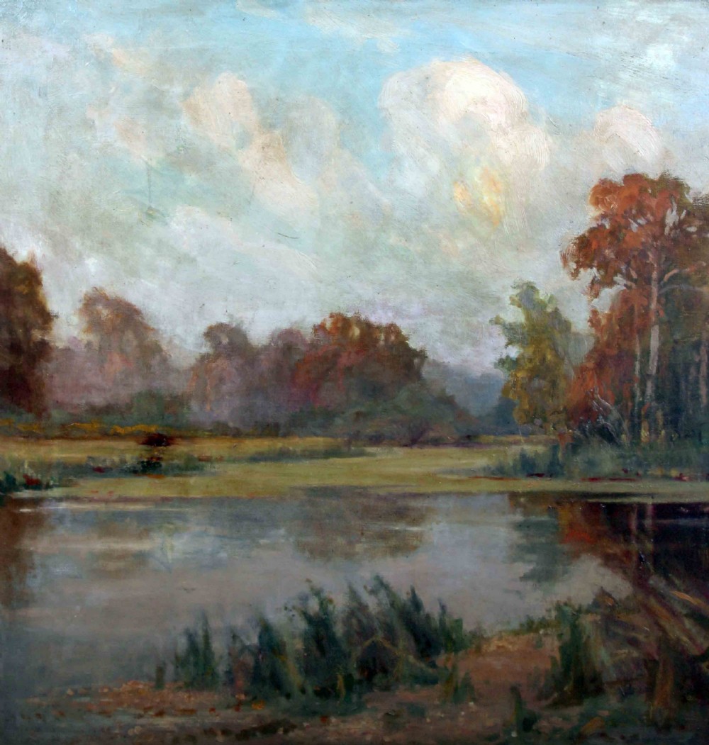 A framed oil painting depicting an autumnal lake landscape with orange trees and reflections on dark water, set within an ornate gilded frame. View X