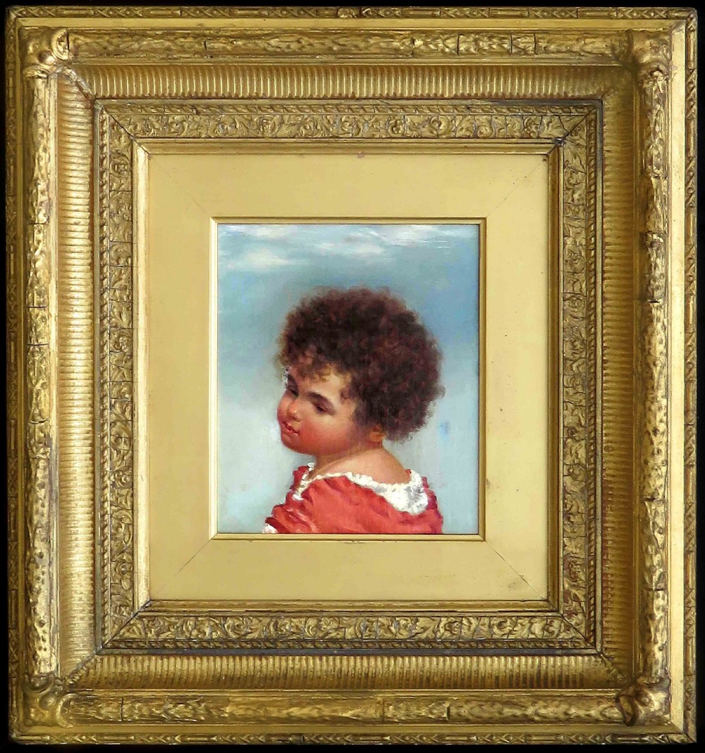 An oil portrait painting of a child with dark curly hair in a red garment, displayed inside a heavy gilt frame.