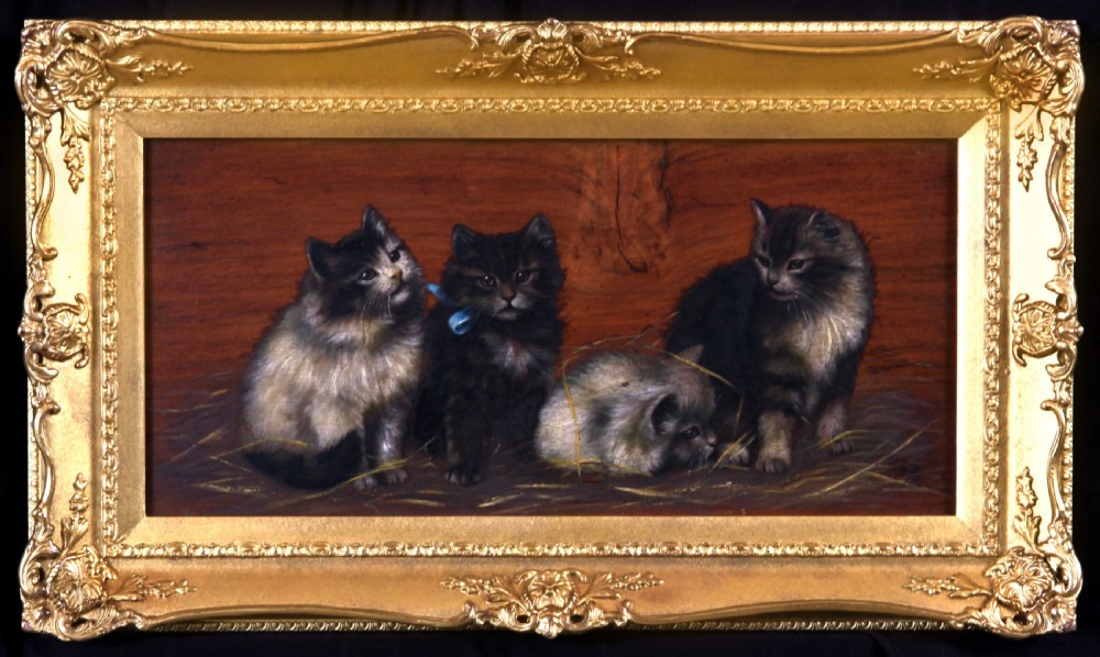A horizontal oil painting depicting four fluffy kittens resting on straw against a wooden background, set within a heavily carved gilt frame.