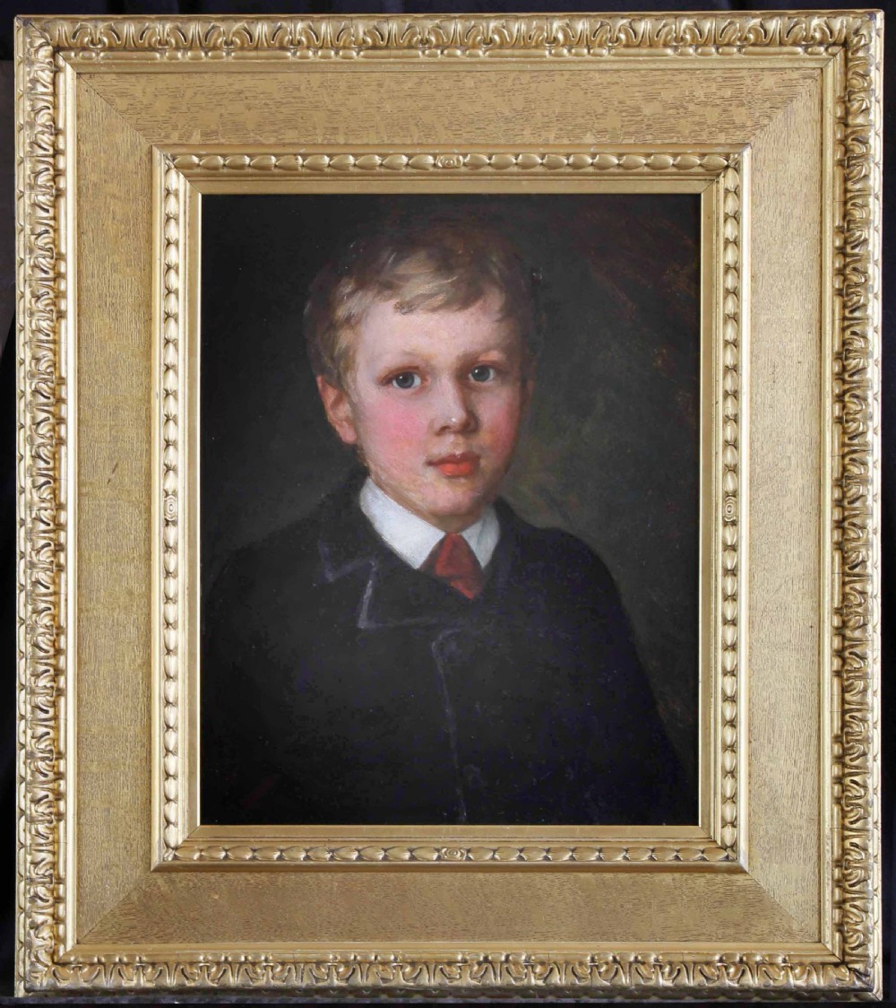 An Edwardian oil painting depicting a young boy in a dark coat, housed inside a decorative gilded frame.