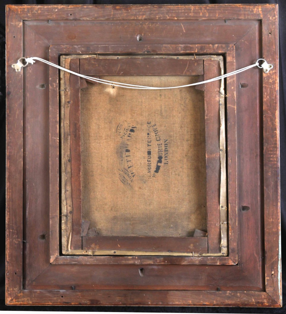 An Edwardian oil painting depicting a young boy in a dark coat, housed inside a decorative gilded frame. View IV