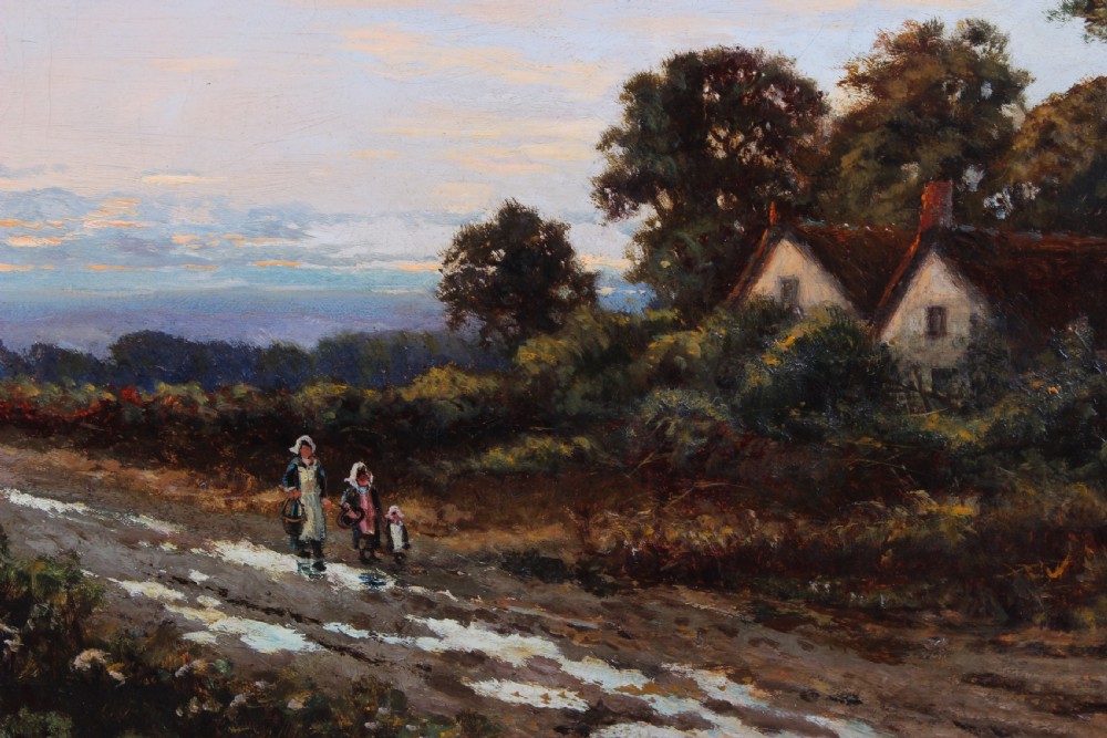 An antique oil painting depicting a rural landscape scene with cottages and tall trees, presented in a moulded giltwood frame. View V