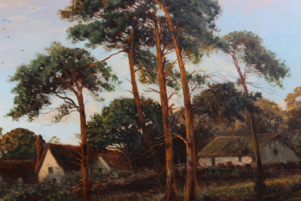 An antique oil painting depicting a rural landscape scene with cottages and tall trees, presented in a moulded giltwood frame. View VI