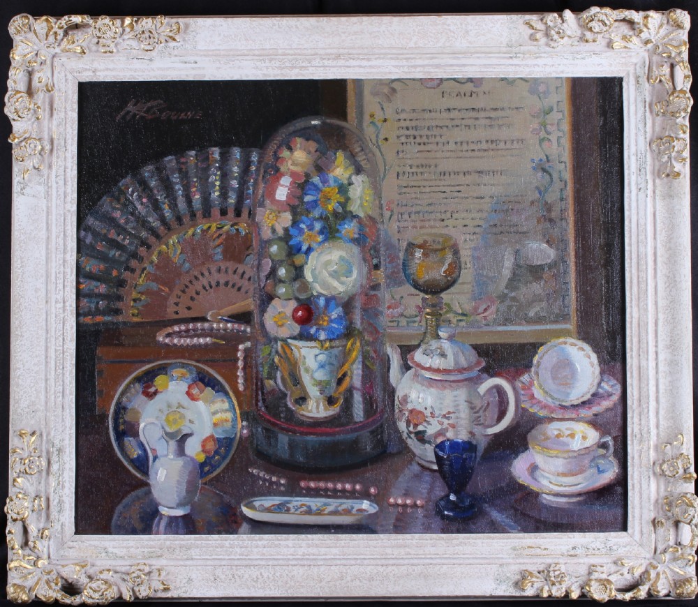 A still life oil painting depicting an arrangement of household objects including a glass cloche with flowers, teacups, a teapot, a folding fan, and a framed script. View II