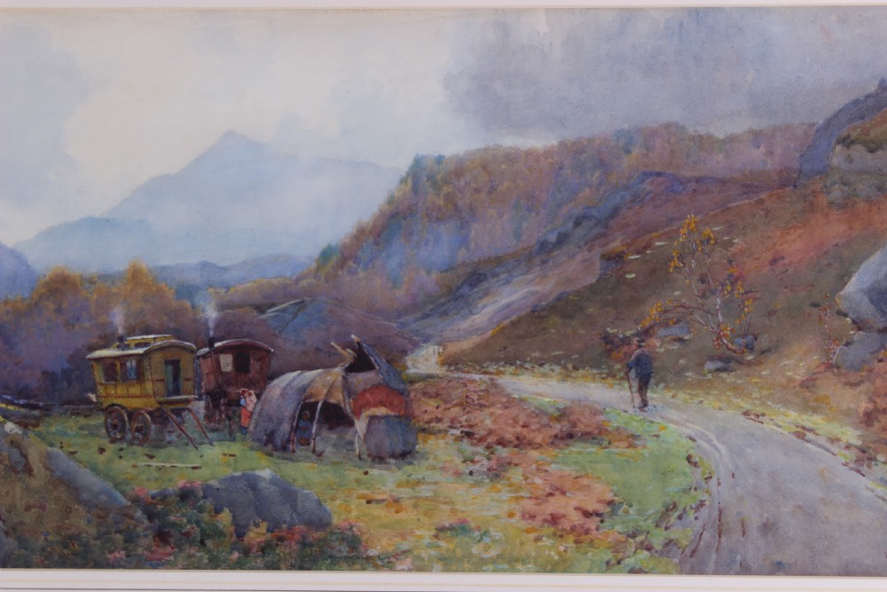 A framed watercolour landscape painting by Willie Stephenson depicting a gypsy encampment with traditional caravans and a tent along a mountain path. View VI