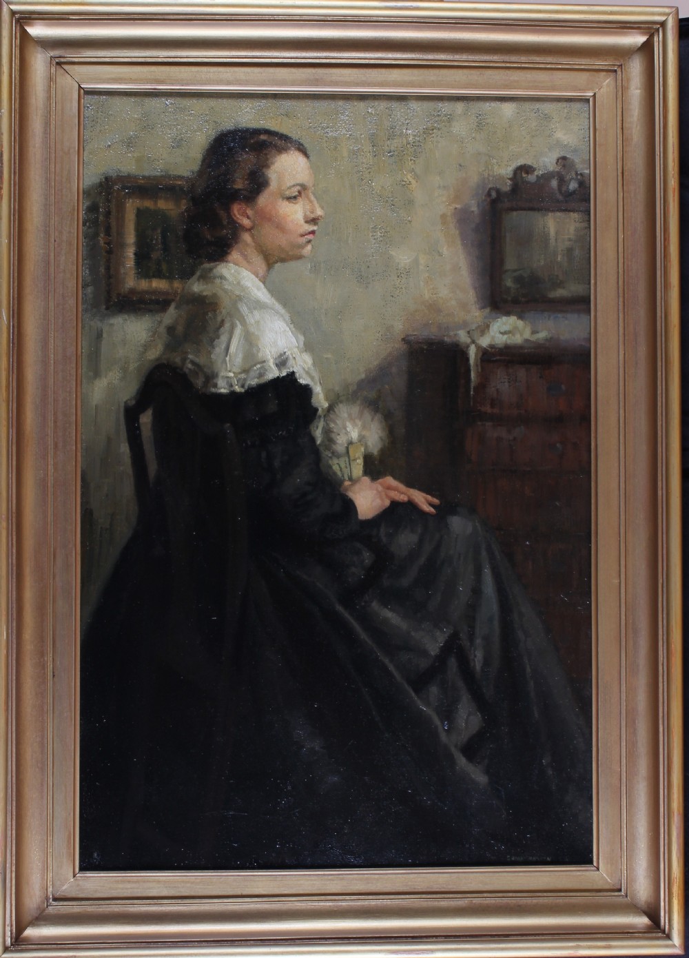 A mid-twentieth-century oil painting on canvas depicting a seated woman in profile wearing a dark dress and white lace shawl within an interior setting. View II