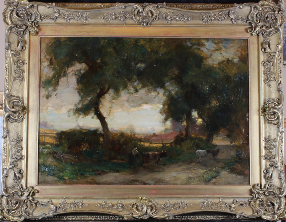 An antique oil landscape painting depicting a twilight pastoral scene with cattle on a dirt track under trees, enclosed in an ornate gilded swept frame.