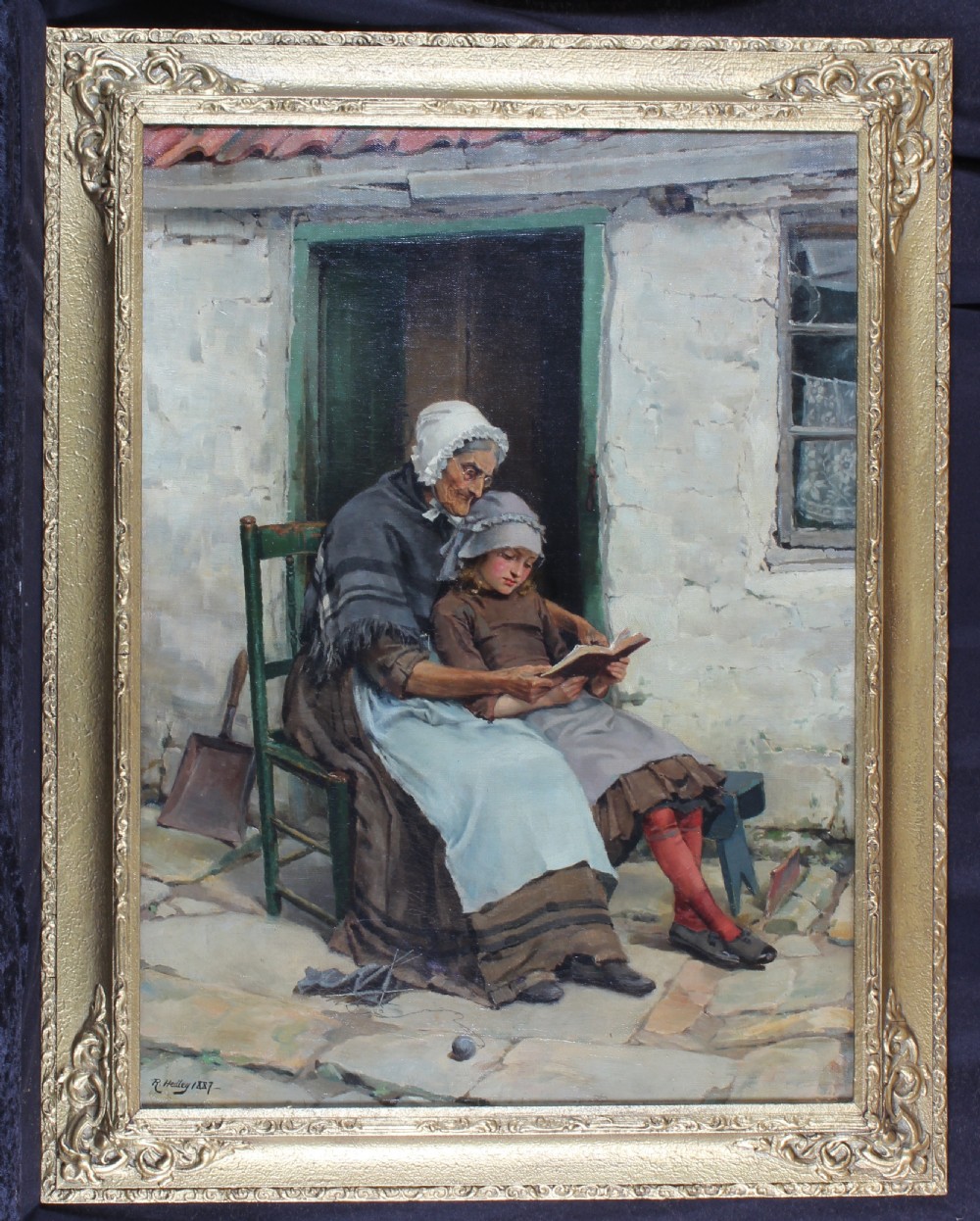 An 1887 oil painting by Ralph Hedley depicting an elderly woman in a bonnet sitting outside a cottage doorway while reading a book with a young girl. View II