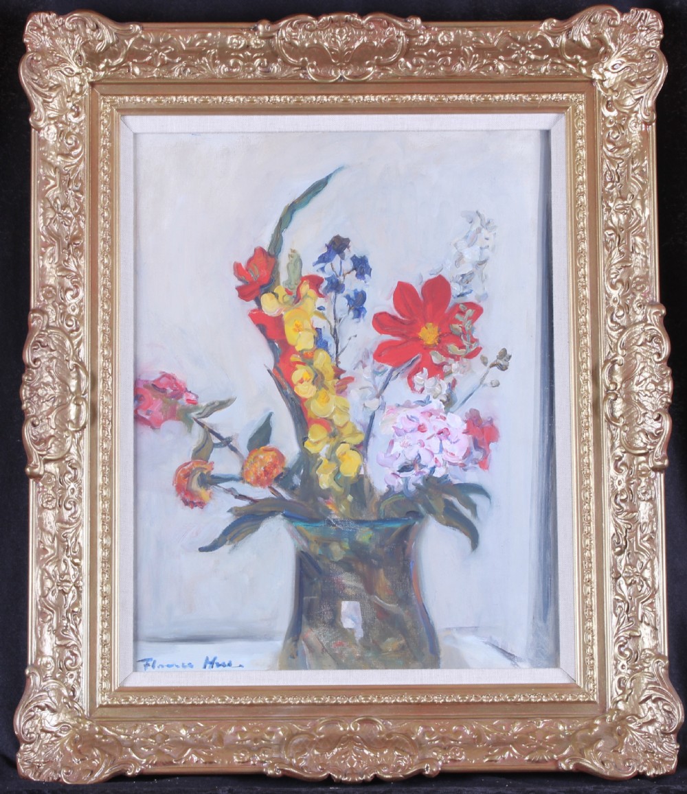 A framed oil painting depicting a colourful floral arrangement in a glass vase within an ornate gilded Rococo-style frame.