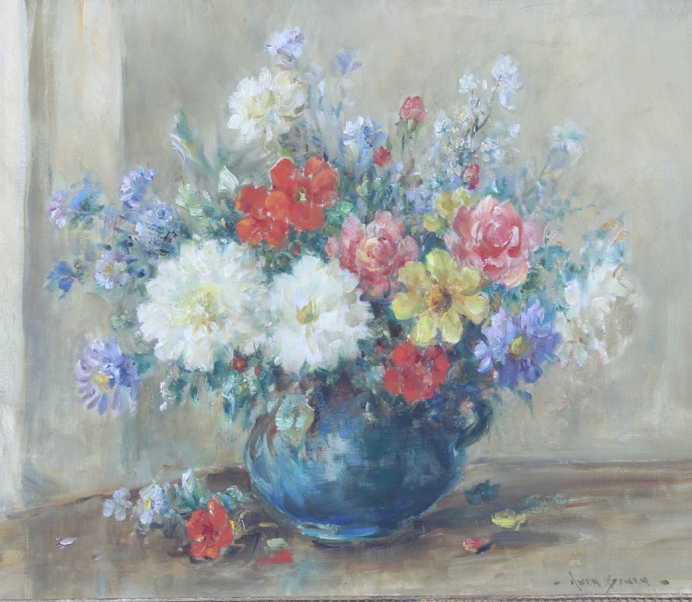 An impressionist still life oil painting depicting a vase of summer flowers in shades of white, red, yellow, and blue set upon a wooden surface.