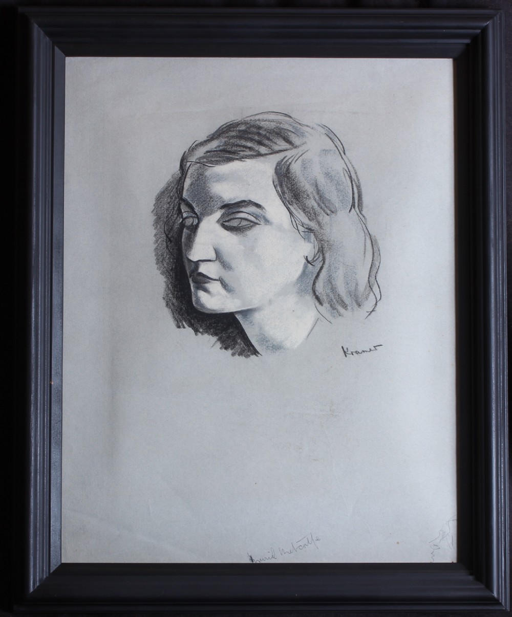 A framed monochrome ink and charcoal portrait drawing depicting the head and shoulders of a woman on light paper, set inside a dark moulded wooden frame.