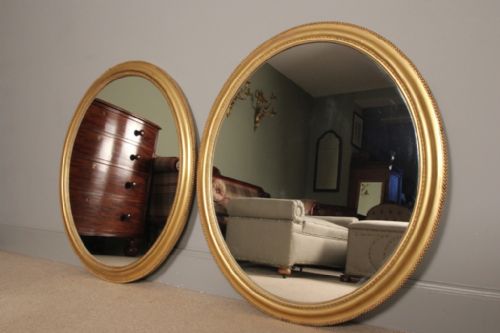 A Pair of Giltwood Oval Mirrors