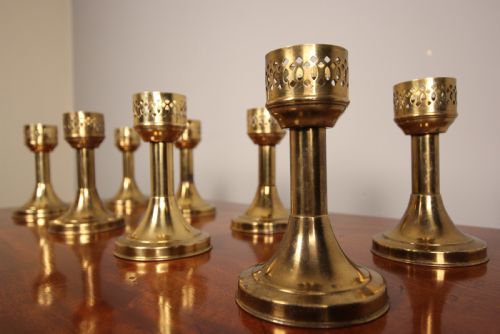 A Run of 8 Decorative Brass Candlesticks