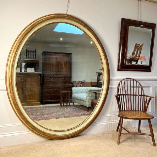 AN IMPRESSIVE LARGE GILTWOOD GESSO OVAL MIRROR - ADDITIONAL PHOTO 1
