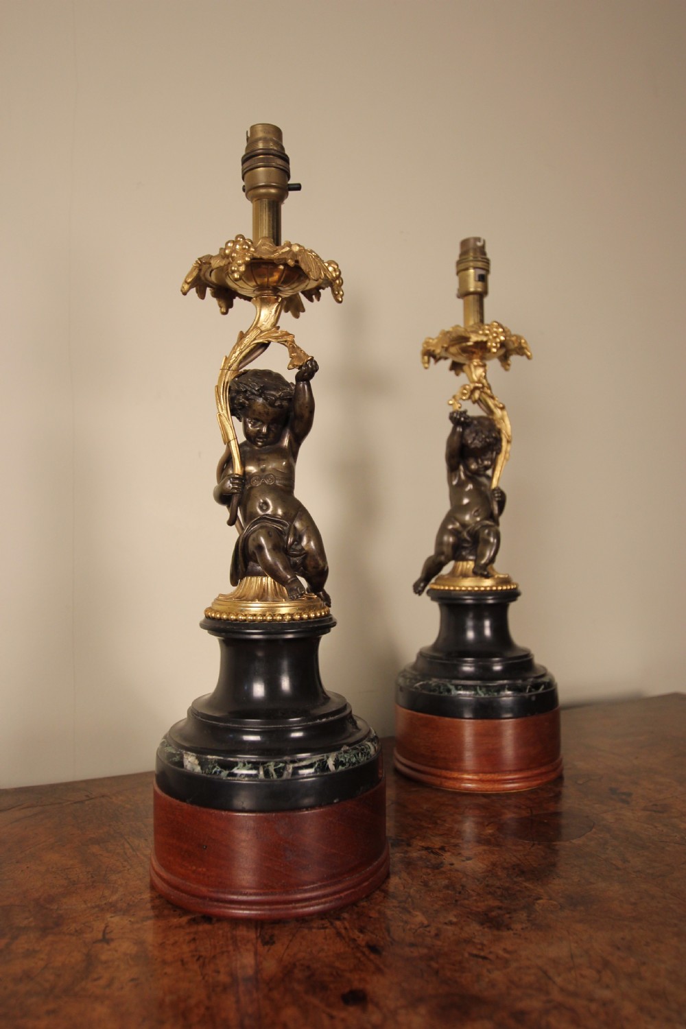 A Pair of Bronze, Ormolu & Marble Cherub Lamps