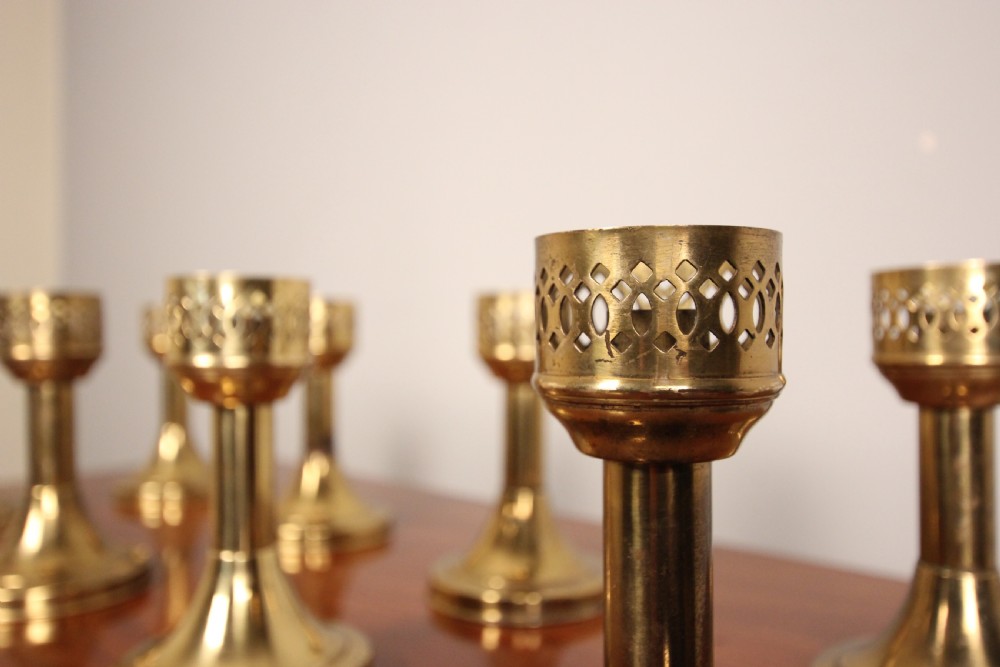 A run of 8 Decorative Brass Candlesticks View II