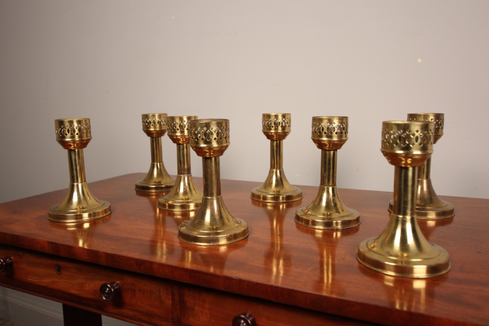 A run of 8 Decorative Brass Candlesticks View III