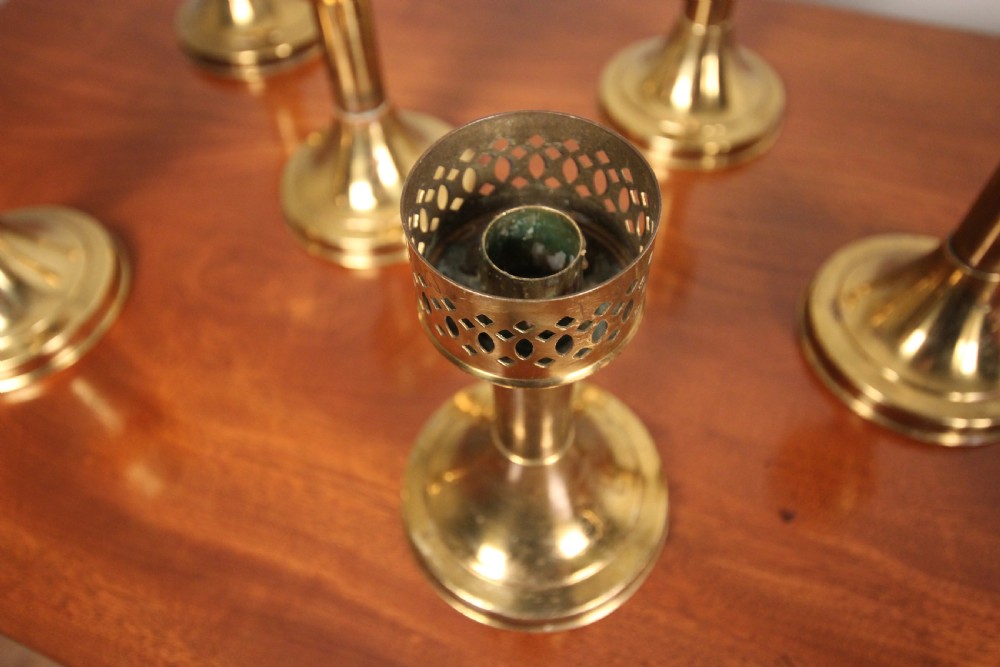 A run of 8 Decorative Brass Candlesticks View IV