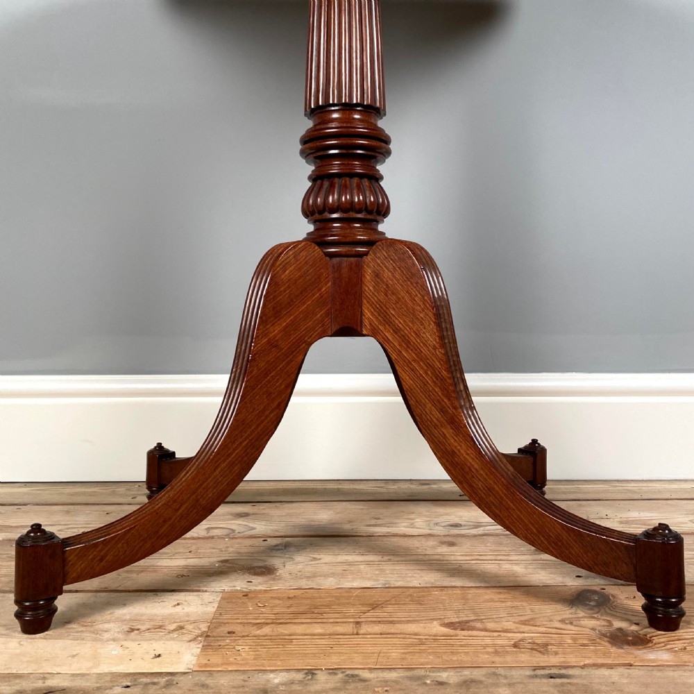 A Regency mahogany occasional table with a rectangular top, reeded pedestal column, and tripod base. View II
