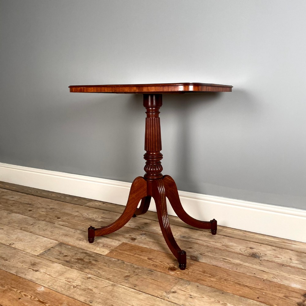 A Regency mahogany occasional table with a rectangular top, reeded pedestal column, and tripod base. View III