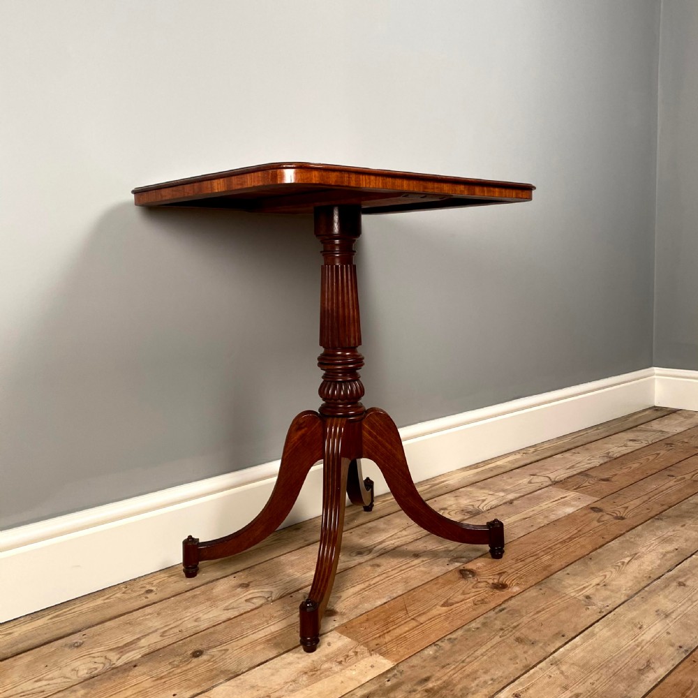 A Regency mahogany occasional table with a rectangular top, reeded pedestal column, and tripod base. View IV
