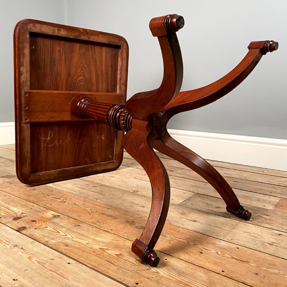 A Regency mahogany occasional table with a rectangular top, reeded pedestal column, and tripod base. View V