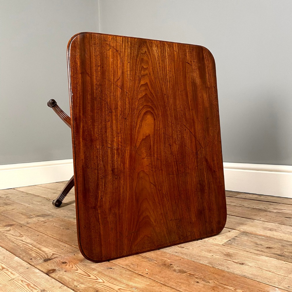 A Regency mahogany occasional table with a rectangular top, reeded pedestal column, and tripod base. View VI