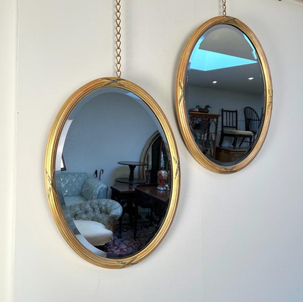 A Pair Of Edwardian Giltwood Oval Mirrors In The Georgian Style
