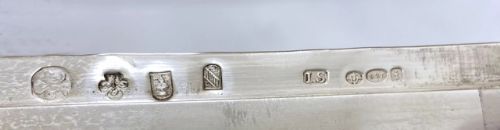 fig 1. A rectangular George V silver box featuring an intricately engraved scene depicting hunters and hounds in a forest landscape.