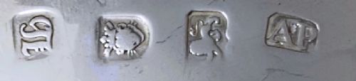 fig 1. A pair of 18th-century sterling silver sauce boats featuring scalloped rims, scroll handles, and three shell-capped legs.