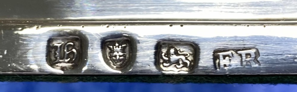 A pair of George III sterling silver candlesticks featuring fluted Corinthian columns mounted on square stepped bases. View III