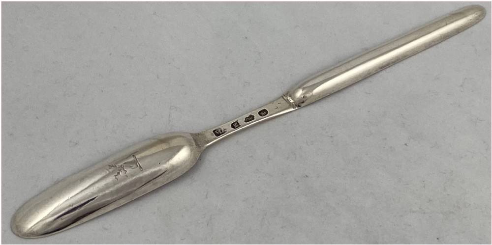 An eighteenth-century Georgian Irish sterling silver marrow scoop featuring a narrow elongated double-ended design. View IV