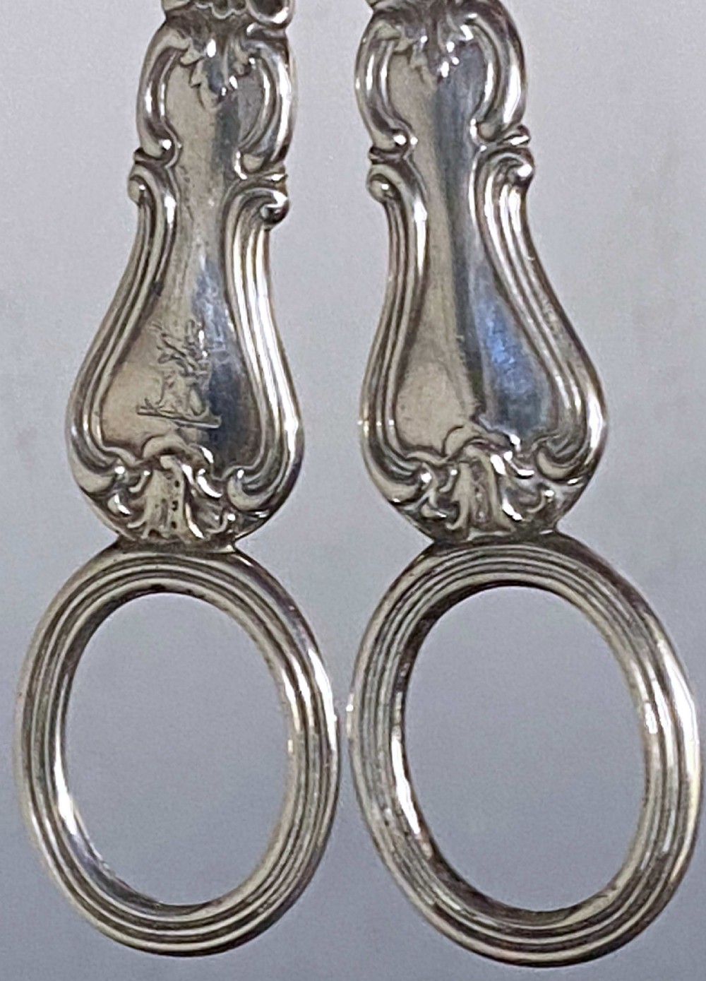 A pair of Victorian sterling silver grape scissors featuring Albert pattern handles with reeded finger loops. View II