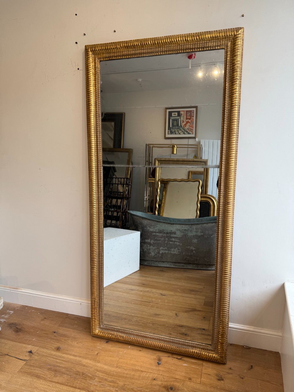 Massive French antique ripple frame gilt mirror