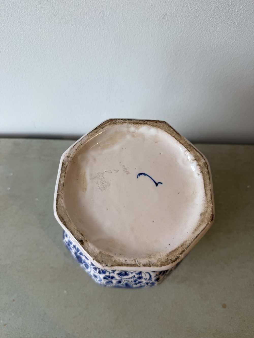 A pair of octagonal tin-glazed earthenware lidded vases decorated with hand-painted blue floral patterns on a white ground, topped with pointed finials. View VIII