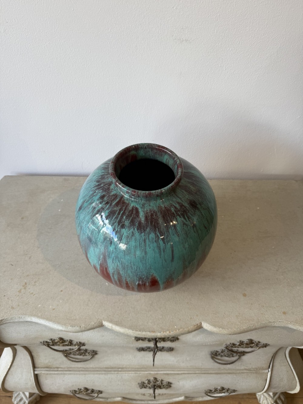 A large bulbous French ceramic vase featuring a dripped turquoise and deep red glossy glaze finish. View II