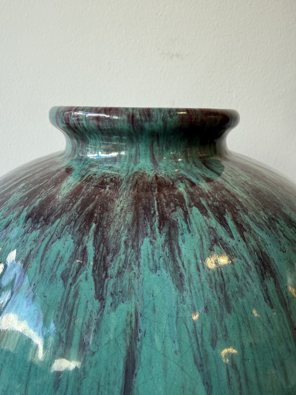 A large bulbous French ceramic vase featuring a dripped turquoise and deep red glossy glaze finish. View V