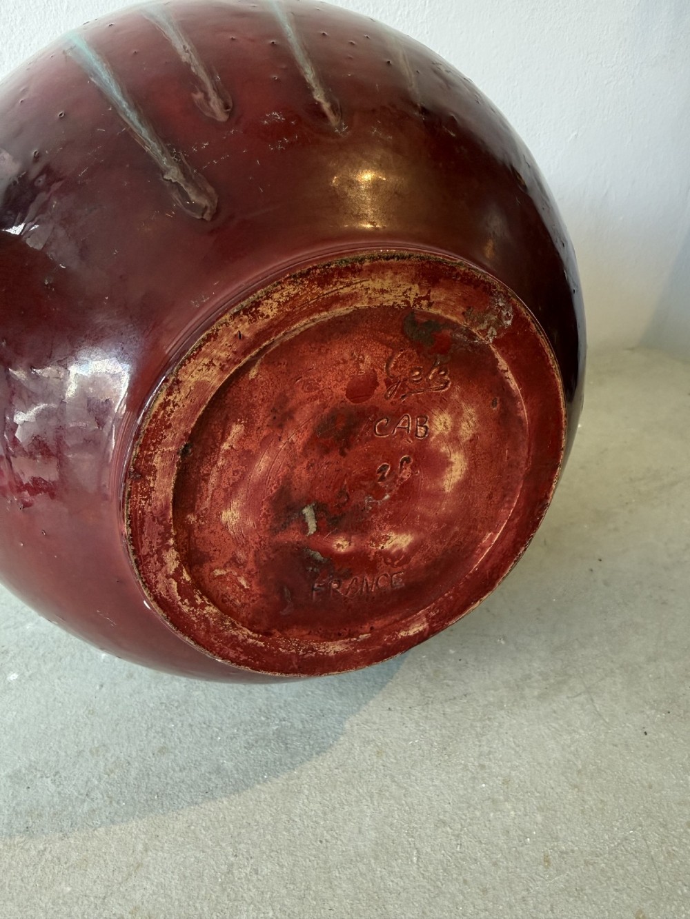 A large bulbous French ceramic vase featuring a dripped turquoise and deep red glossy glaze finish. View VI