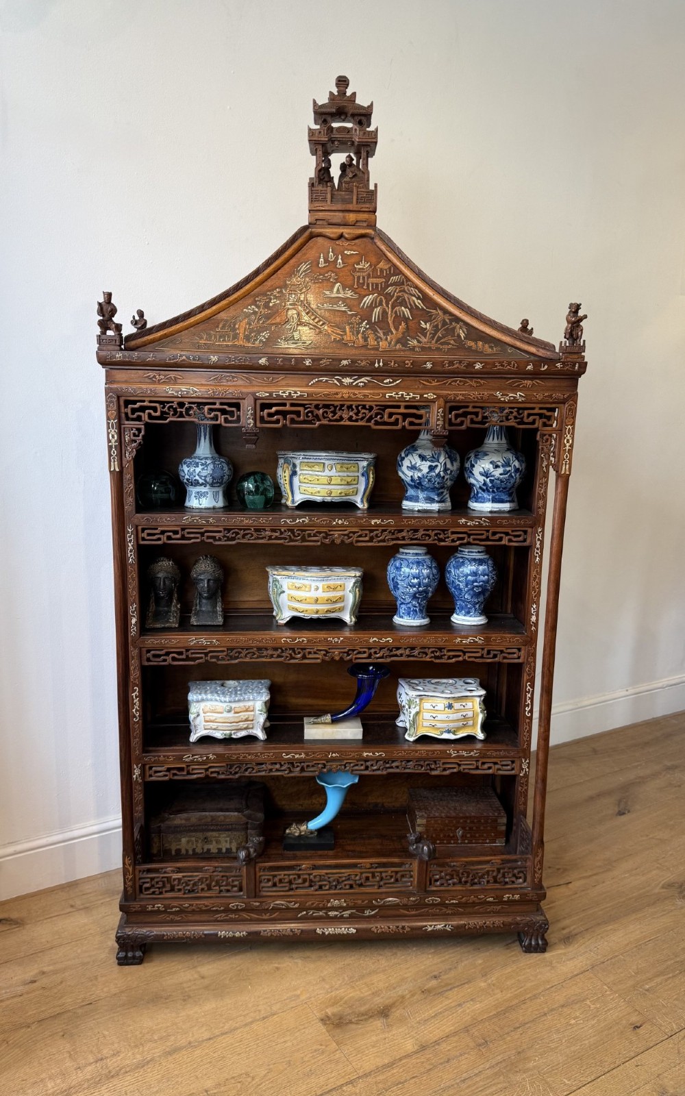 A tall dark wood Chinese pagoda display cabinet featuring mother of pearl inlay, carved fretwork, and four open shelves. View II