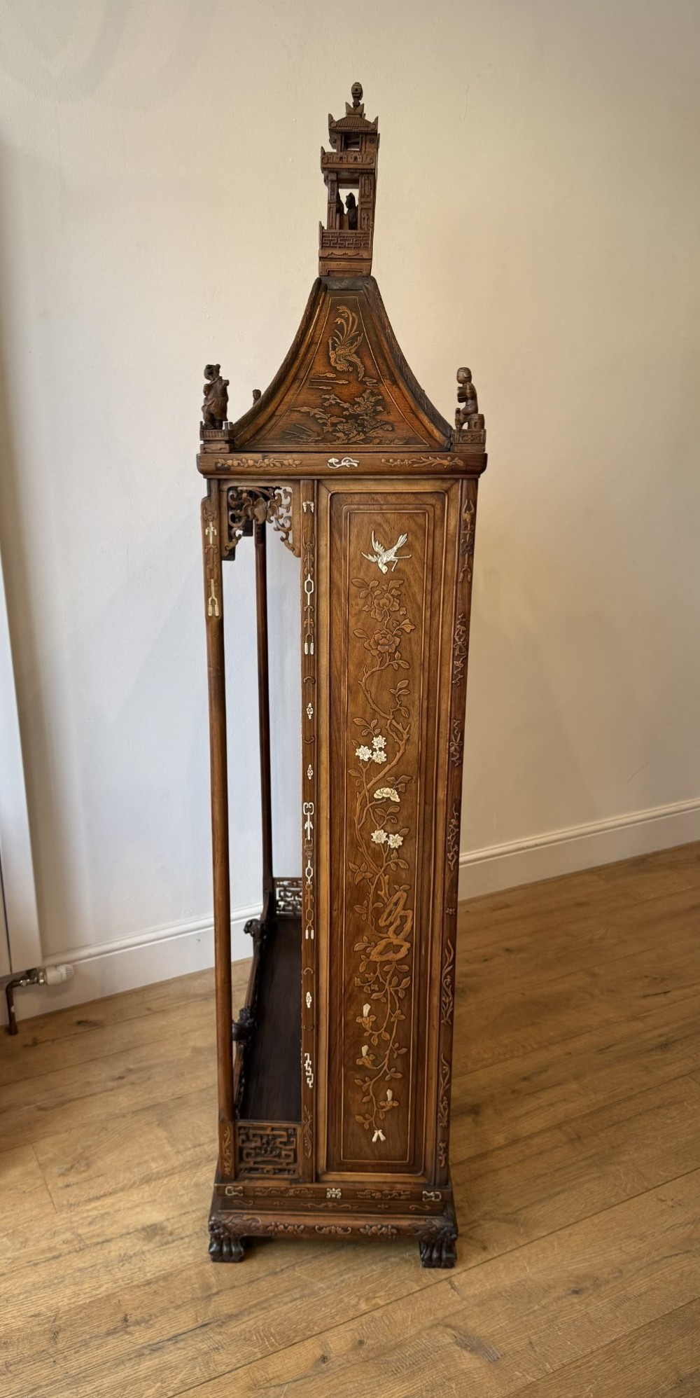 A tall dark wood Chinese pagoda display cabinet featuring mother of pearl inlay, carved fretwork, and four open shelves. View IV