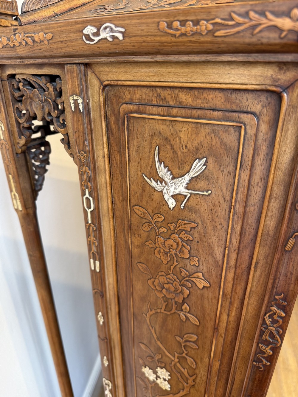 A tall dark wood Chinese pagoda display cabinet featuring mother of pearl inlay, carved fretwork, and four open shelves. View VIII