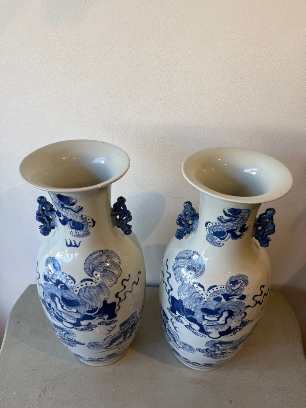 A pair of large Chinese porcelain baluster vases painted in cobalt blue underglaze with guardian lion motifs and decorative scrolled handles. View III