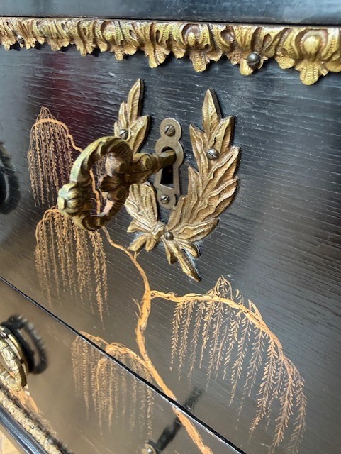 A pair of black lacquered Louis XVI style commodes featuring gold gilt Chinoiserie landscapes, marble tops, and tapered fluted legs. View VII