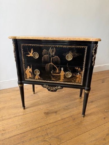 A pair of black lacquered Louis XVI style commodes featuring gold gilt Chinoiserie landscapes, marble tops, and tapered fluted legs. View III
