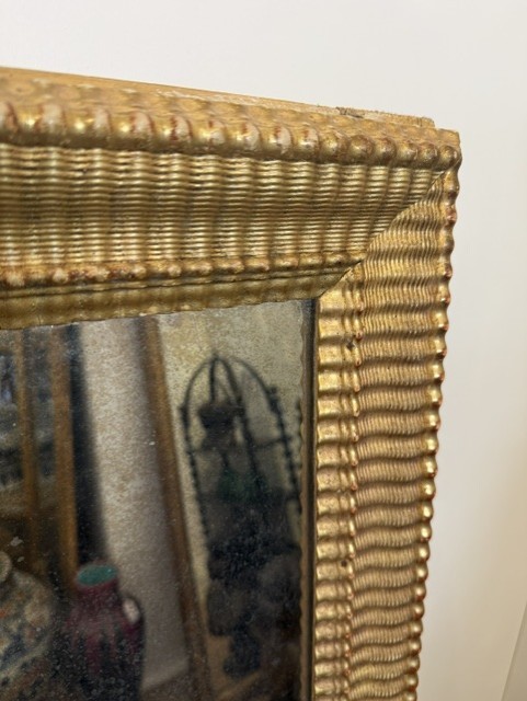 A large rectangular 19th-century wall mirror featuring a textured gold ripple-moulded frame. View II