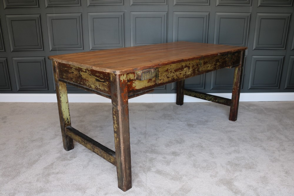 A rectangular rustic farmhouse table featuring a polished natural pine top and a heavily distressed green painted base with square legs. View IV
