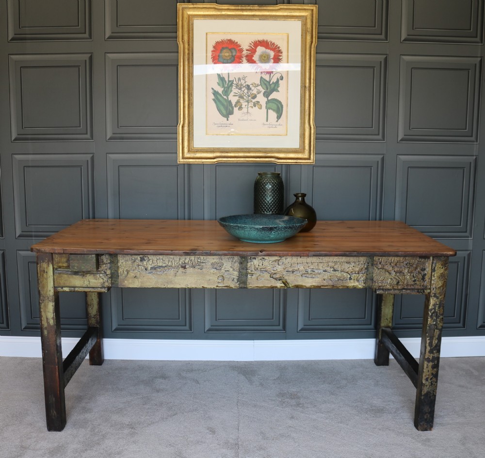 A rectangular rustic farmhouse table featuring a polished natural pine top and a heavily distressed green painted base with square legs. View VII