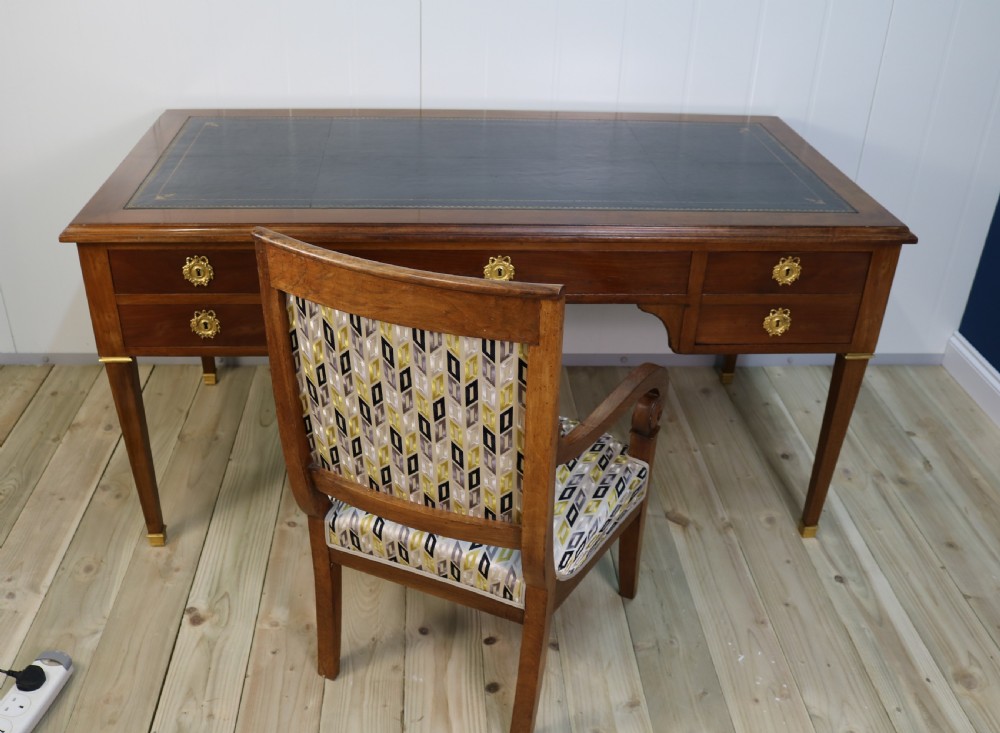 A pair of nineteenth-century French walnut fauteuils featuring scrolled armrests, raked backs, and patterned geometric upholstery. View VIII