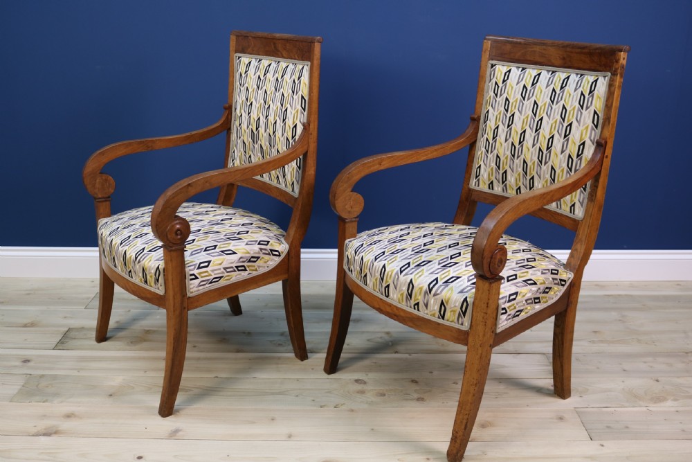 A pair of nineteenth-century French walnut fauteuils featuring scrolled armrests, raked backs, and patterned geometric upholstery. View XI