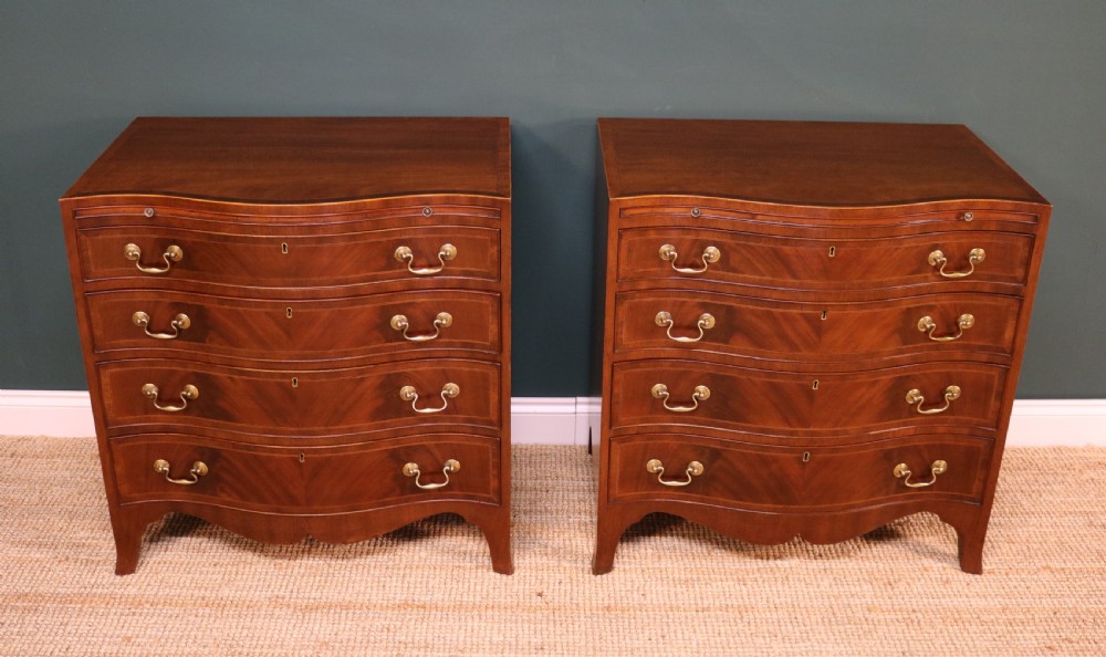A Pair of George III Revival Serpentine Chest of Drawers